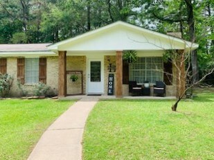 Lovely front porch to enjoy morning coffee or watch the kids play in the fenced yard
