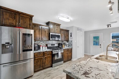 Gorgeous Counter tops and cabinets. Fridge stays