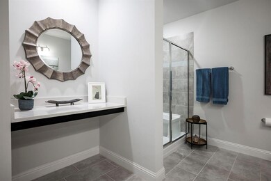 Vanity area and large shower with bench