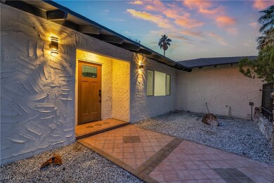 Exterior entry at dusk featuring a patio and stucc