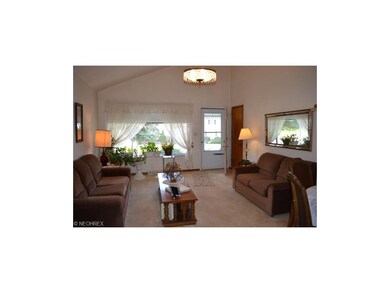 Wonderful lofted living room with carpeting and la