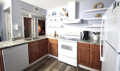 Kitchen with visible vents, open shelves, under ca