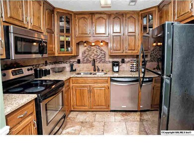 Tons of cabinet and counter space in this fantastic kitchen with gorgeous tile backsplash and stainless steel appliances.