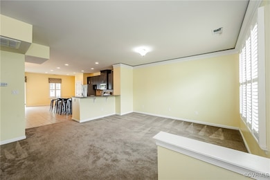 Unfurnished living room with light carpet, recesse