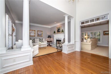 Living room featuring crown molding, a fireplace,