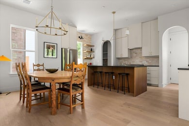 Dining area featuring visible vents, light wood-s
