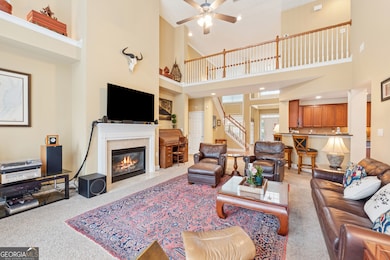 Vaulted light-filled 2 story family room with open view to Chef's kitchen, gas fireplace, oversized windows, plus French doors leading to rear patio.