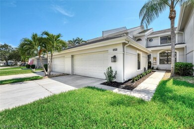 View of side of property with a garage and a lawn