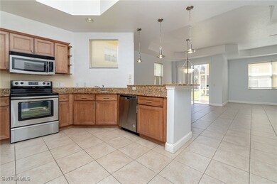 Kitchen with light tile patterned floors, stone co