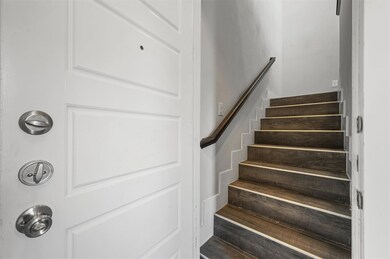 Stairway with dark wood-type flooring