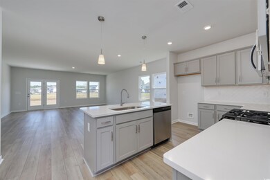 Kitchen with a center island with sink, stainless 