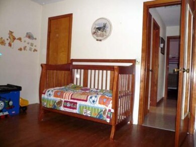 2nd bedroom with original hardwood flooring.