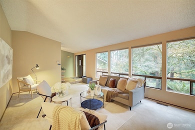 Expansive living room with large windows to front yard.