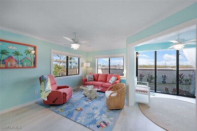 Living room featuring ceiling fan and wood-type fl