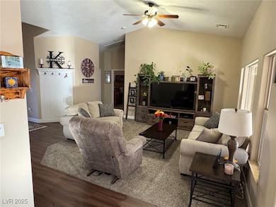 Living area with ceiling fan, wood finished floors