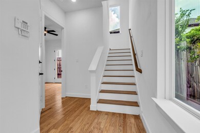 Step into this inviting entryway, where bright, durable engineered wood floors greet you with warmth and elegance.