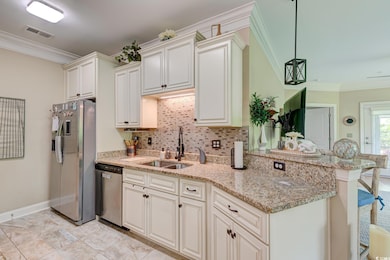 Kitchen featuring visible vents, ornamental moldin