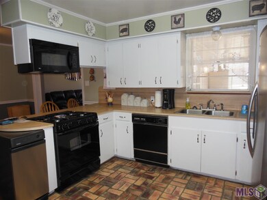 Freshly painted cabinets with gas stove top and br