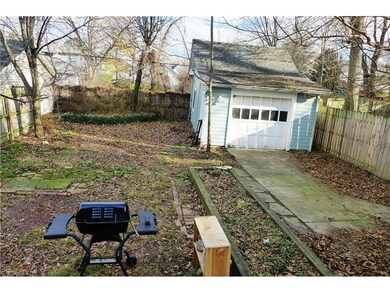 Wood privacy fence goes around full perimeter of driveway and double swing wooden fence also extends across driveway to keep pets harnessed in from getting lost.