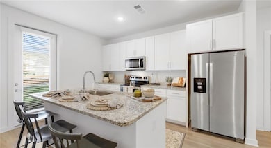 Kitchen featuring a healthy amount of sunlight, ap