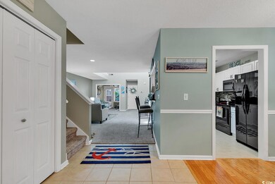 Corridor with light carpet, stairs, baseboards, an