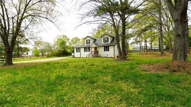 View of front facade featuring a front yard, fence, and crawl space