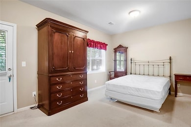 Bedroom with baseboards, multiple windows, and car