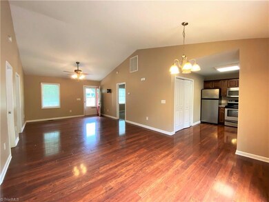 Living room with view of kitchen from dining area