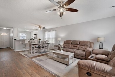 Living area with wood-type flooring, visible vents