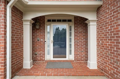 View of exterior entry featuring brick siding