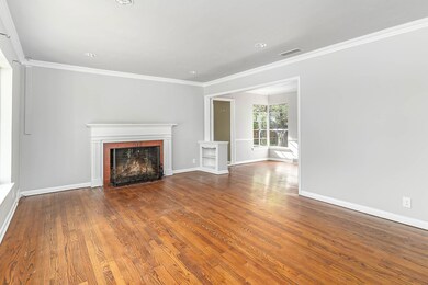 Unfurnished living room featuring ornamental moldi