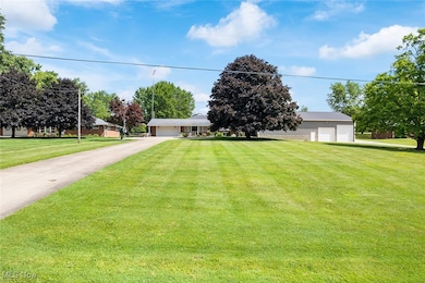 View of front of home featuring a garage and a front yard