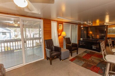 Living room with carpet, a healthy amount of sunli