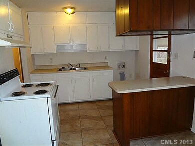 Kitchen - Kitchen has center island and ceramic ti