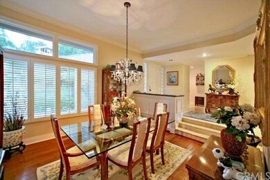 Formal dining room with rich hardwood floor, shutt