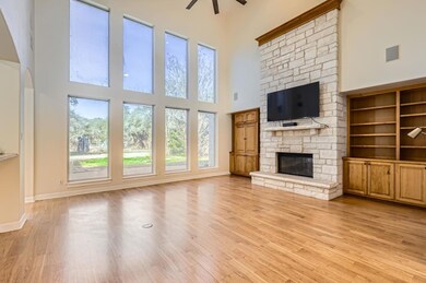 Unfurnished living room featuring a ceiling fan, 