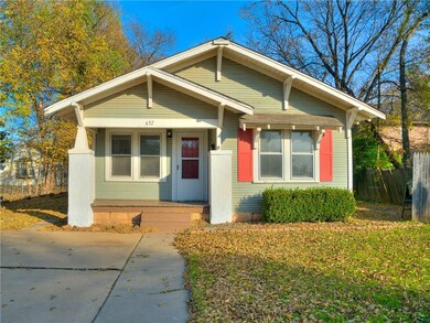 Front elevation; side yard has firepit and patio.