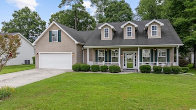 Cape cod house featuring a garage, a porch, centra