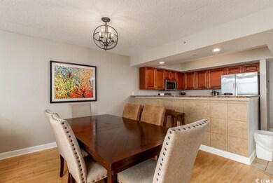 Dining area with light wood finished floors, a cha