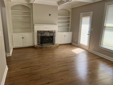 Unfurnished living room with built in shelves, dar
