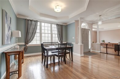 Dining space with crown molding, a raised ceiling,