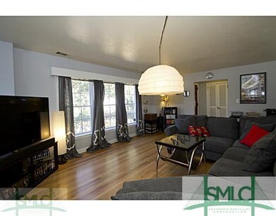 Living Room. GLEAMING HARDWOOD FLOORS W WOOD BURNI