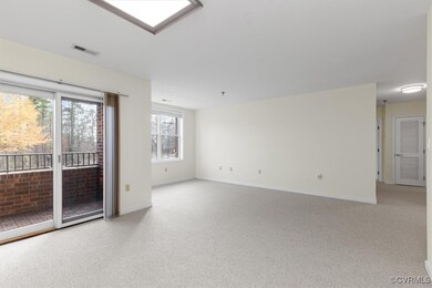 Empty room featuring light colored carpet