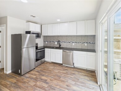 Kitchen featuring appliances with stainless steel