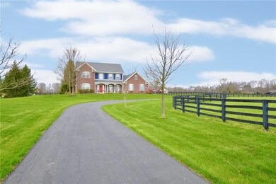 View of front elevation coming up the drive along the front pasture.