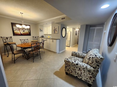 Tiled dining room with crown molding, a notable ch