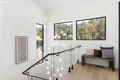 Staircase with wood finished floors and a towering ceiling