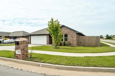Ranch-style house with driveway, brick siding, an attached garage, and roof with shingles