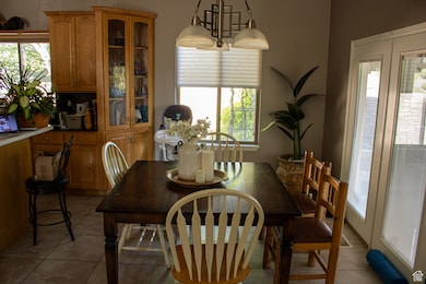 Dining space with healthy amount of natural light and light tile patterned floors