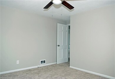 Carpeted spare room featuring a textured ceiling a